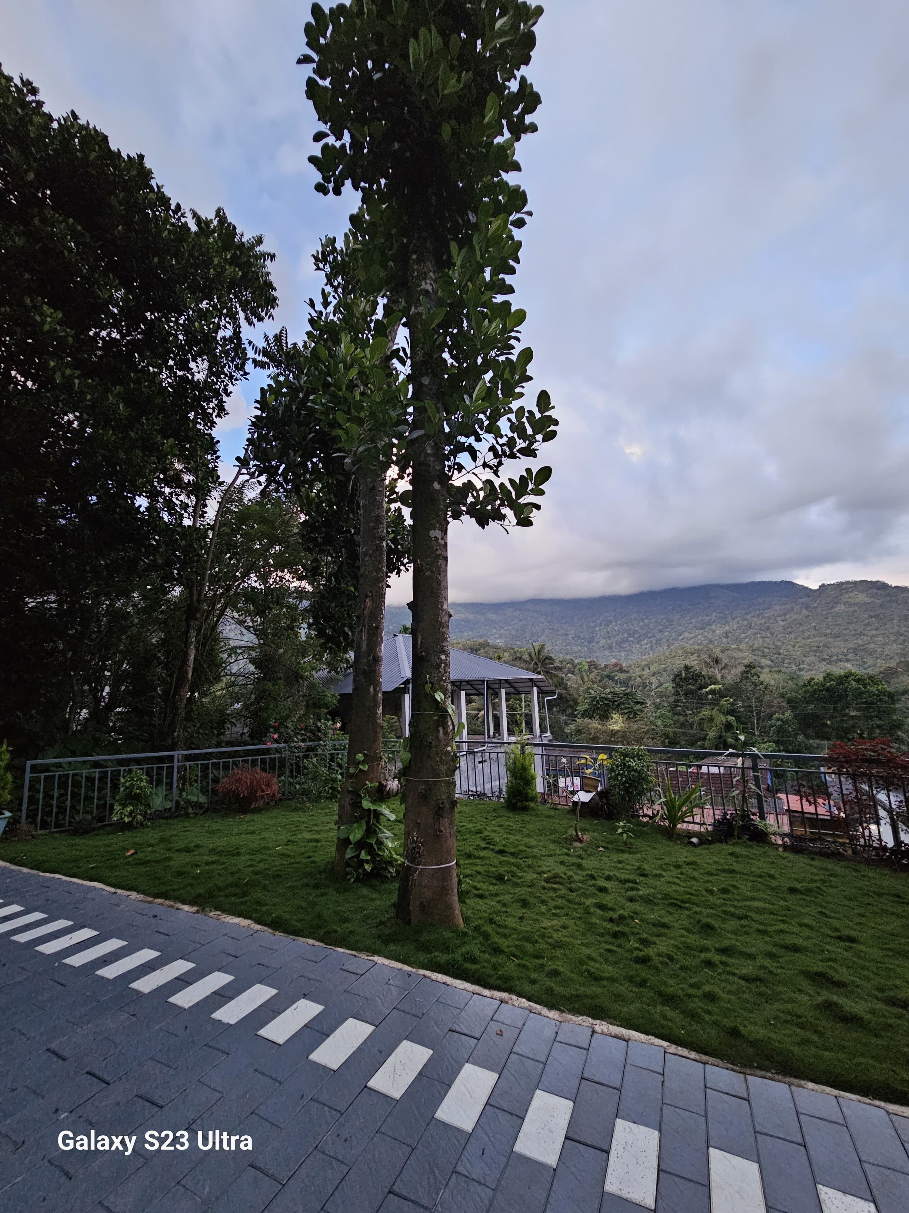 Outdoor dining area with scenic mountain backdrop at Bhaskar Home Munnar